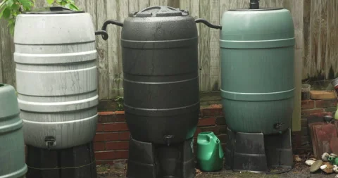Three connected water barrels storing harvesting rain water, 動画素材 310950657
