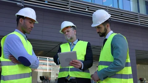 Three construction engineers having a discussion on building site. Stock Footage 287040277