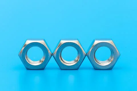 Three construction hex nuts shot in close-up photo Stock Photos