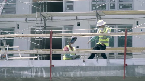 Three Construction Workers on Scaffolding Stock Footage 63356922