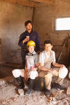 Three construction workers on their lunch break Stock Photos