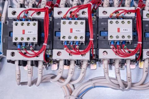 Three contactors with front additional contacts in the electrical Cabinet. Stock Photos