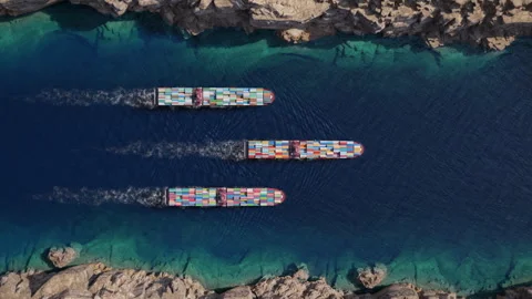 Three container ships crossing narrow rocky coastal strait Stock Footage 340332426
