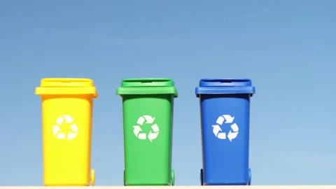 Three container trash bin for recycling on blue sky background. Yellow, green Stock Footage 268569217