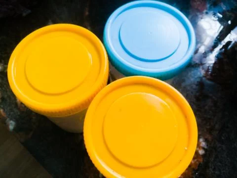 Three containers placed in a table making a triangle shape. Stock Photos