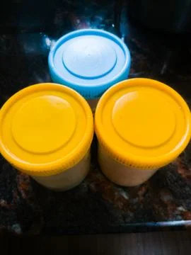 Three containers placed in a table making a triangle shape. Stock Photos