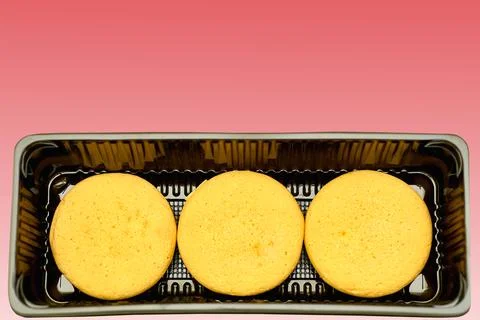 Three cookies in plastic packaging on red Stock Illustration