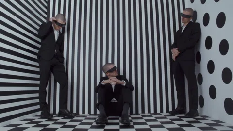 Three copies of the same man in a black and white room Stock Footage 258189128