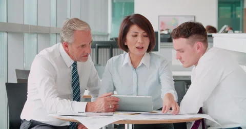 Three corporate colleagues meeting in an office Stock Footage 59918853