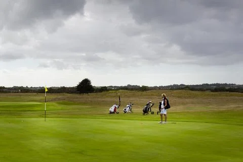 Three couples golf player playing golf in professional golf course. Stock-Fotos