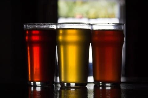 Three craft beer styles in pint glasses with dramatic backlighting Photos