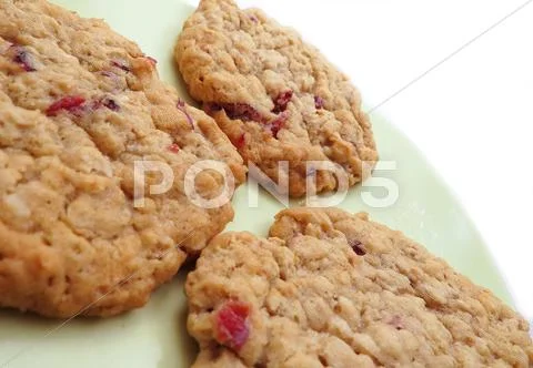 Three cranberry oatmeal cookies Stock Photos