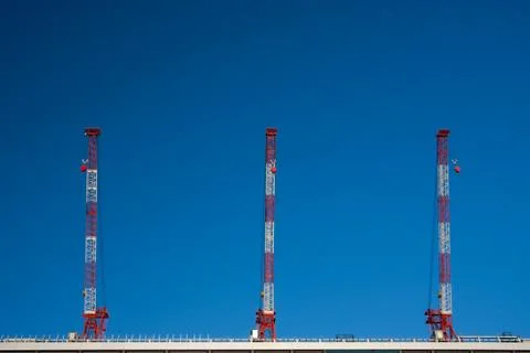 Three cranes on top of building. Copy space Stock Photos