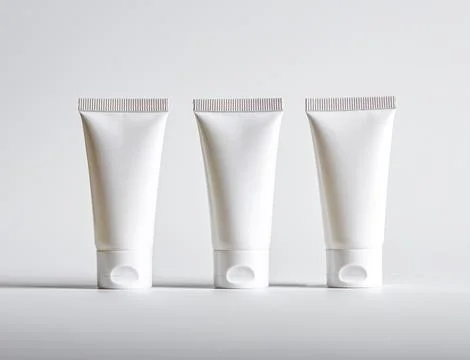 Three cream tubes row mockups Stock Photos