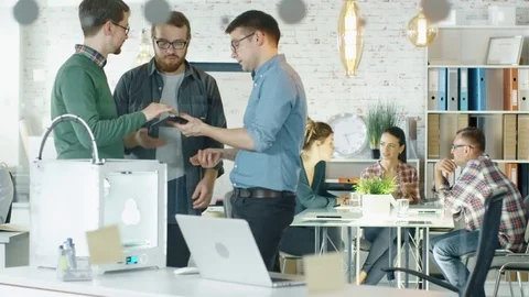 Three Creative Men Discuss Business Matters Passing Tablet to Each Other Stock Footage 70852667
