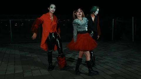 Three Creepy Clowns Dancing and Posing Outdoors at Night Video stock 264355643