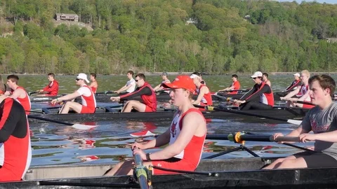 Three Crew Boats Racing up river Stock Footage 80625764