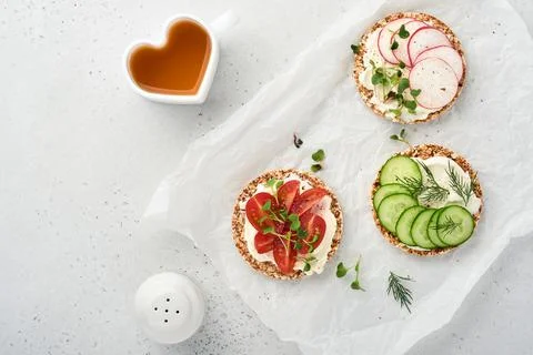 Three crispy buckwheat bread gluten free with cream cheese, radish, tomato, c Stock Photos