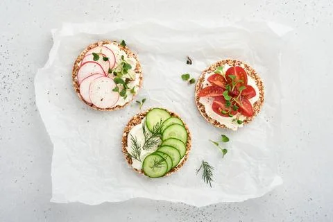Three crispy buckwheat bread gluten free with cream cheese, radish, tomato, c Stock Photos