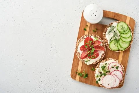 Three crispy buckwheat bread gluten free with cream cheese, radish, tomato, c Stock Photos