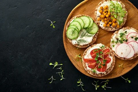 Three crispy buckwheat bread gluten free with cream cheese, radish, tomato, c Stock Photos