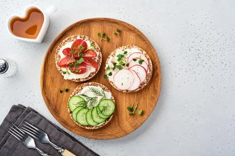 Three crispy buckwheat bread gluten free with cream cheese, radish, tomato, c Stock Photos