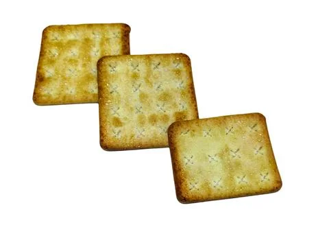 Three crispy square crackers arranged diagonally on a plain. Stock Photos