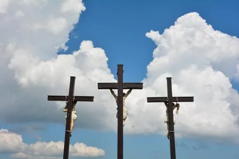 Three crosses in front of clouds and  blue sky Stock Photos