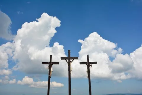 Three crosses in front of white clouds and  blue sky Stock Photos