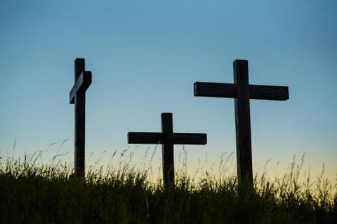 Three crosses on a hill with grass Stock Photos