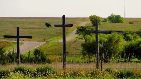 Three crosses on the prairie with fields beyond 스톡 동영상 345530955