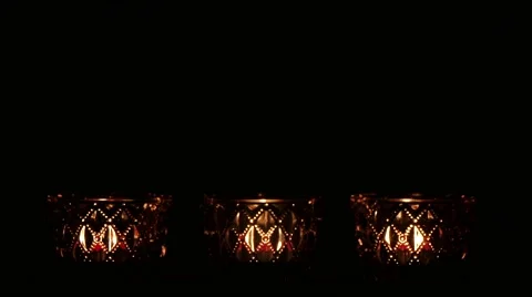 Three crystal tealights with lightning candle in front of black background. Видео 43721507