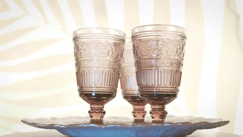 Three crystal wine goblets whirl on a tray. Stock Footage 155105998