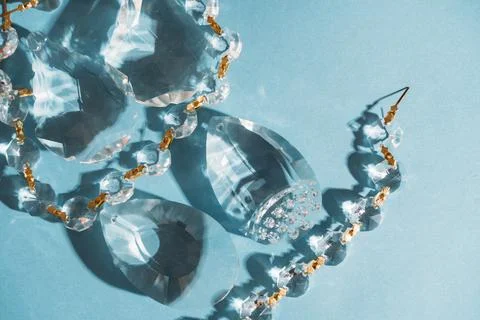 Three crystals with light refraction on blue minimal background Stock Photos