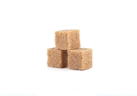 Three cubes of cane sugar on a white background. Stock Photos