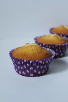 Three cupcakes in a blue wrapper .Texture or background Foto stock