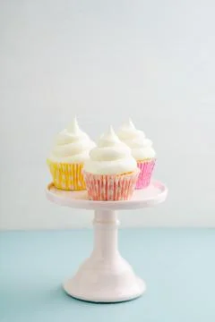 Three cupcakes on cake stand Stock Photos