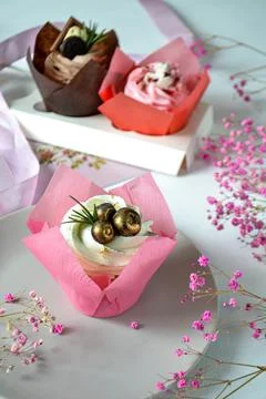 Three cupcakes on a light kitchen table Stock Photos