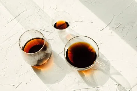 Three cups of fresh brewed coffee on white cement background, selective focus Stock Photos
