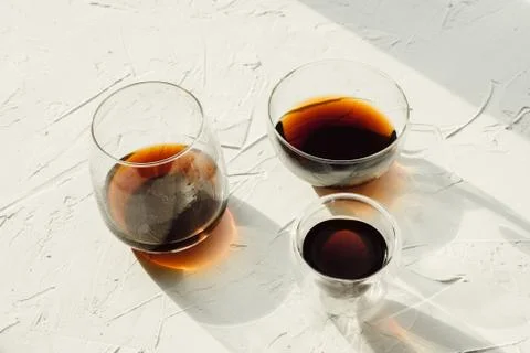 Three cups of fresh brewed coffee on white cement background, selective focus Stock-Fotos