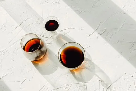 Three cups of fresh brewed coffee on white cement background, selective focus Stock Photos