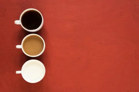 Three cups on red background Stock Photos