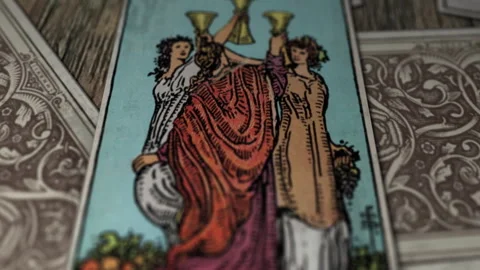 The Three Of Cups shows Three Young Females raising their cups high in the air Stock Footage 305947984