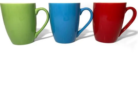 Three cups stand in a row on a white background. Stock Photos