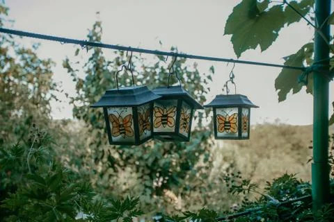 Three cute hanging bee lanterns in the village Stock Photos
