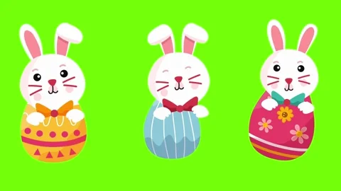 Three cute white rabbits with decorated eggs on green screen Stock Footage 329585493