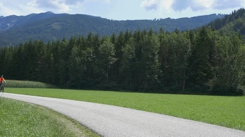 Three cyclist on e-bikes riding leisurely Stock Footage 118402402