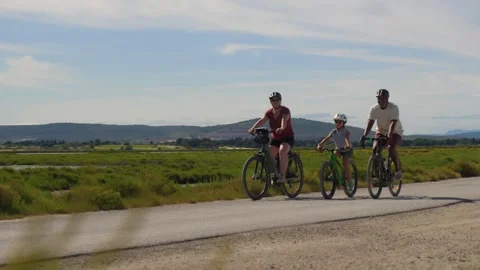 Three Cyclists Ride Rural Path Through Green Countryside Stock Footage 346452595
