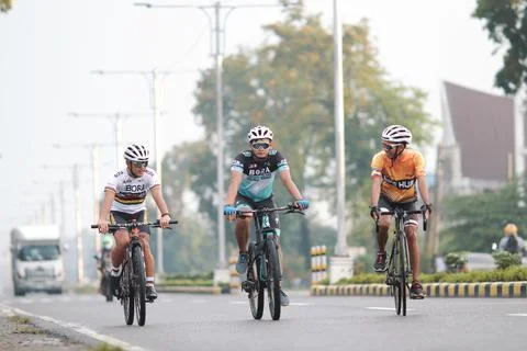 Three Cyclists on the Road in South Cotabato Stock Photos