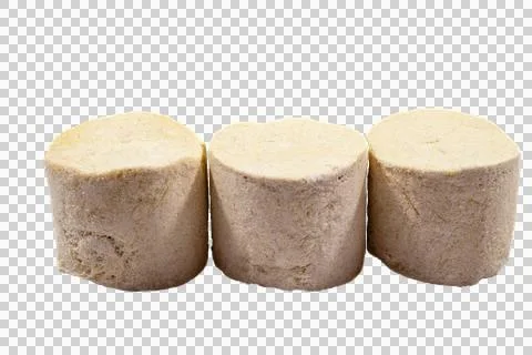 Three cylindrical pieces of beige halva, traditional middle eastern sesame. Stock Photos